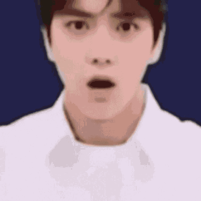 a close up of a person 's face with a surprised look on his face .