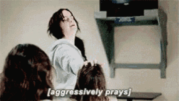 a group of women are sitting in front of a tv and one of them is saying aggressively prays