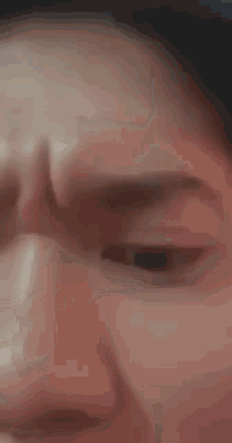 a close up of a person 's face with their eyes closed and their mouth open .
