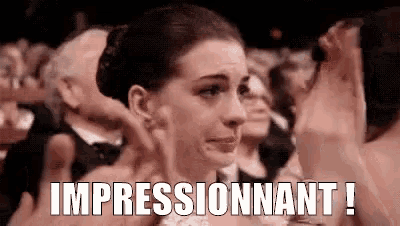 a woman is crying while sitting in a crowd of people at an awards ceremony .