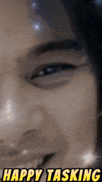 a close up of a person 's face with the words happy tasking written above it