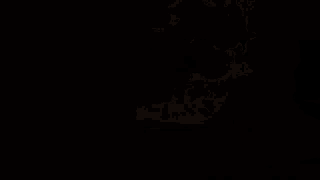 a close up of a person 's hand holding a fireball on a black background .
