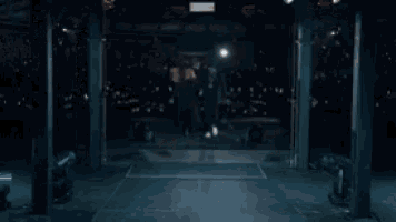a man and woman are standing next to each other in a dark room .