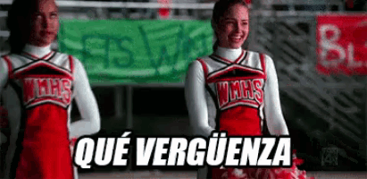 two cheerleaders from wmhs are standing in front of a sign that says ' qué verguenza '