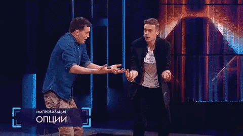 a man in a blue shirt is giving a high five to another man
