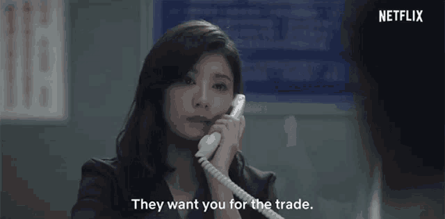 a woman is talking on a telephone and they want you for the trade .