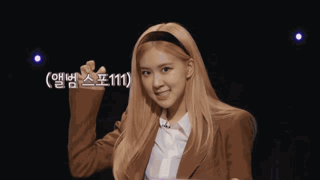 a woman with blonde hair is wearing a brown jacket and a headband