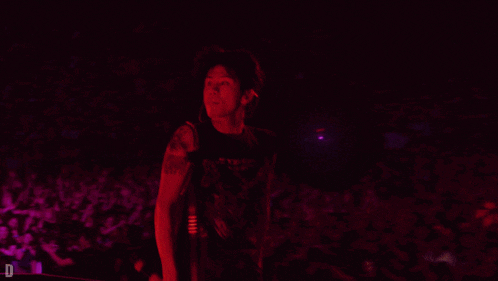 a man in a black tank top with the letter d on the bottom right