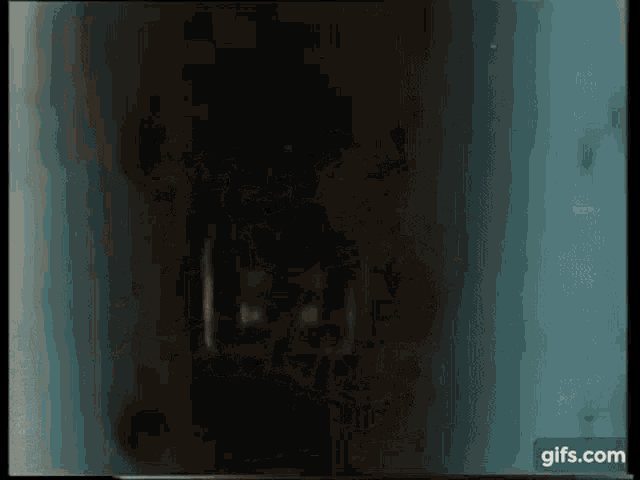 a close up of a person 's face in the dark with a blue background .