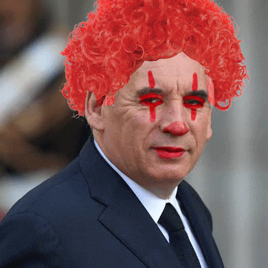 a man in a suit has a red clown wig on