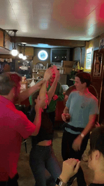 a group of people are dancing in front of a sign that says ' a & w '