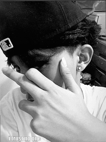a man covering his face with his hand and the words i trust no one below