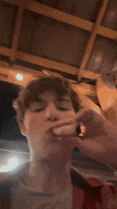 a man smoking a cigarette with smoke coming out of his nose