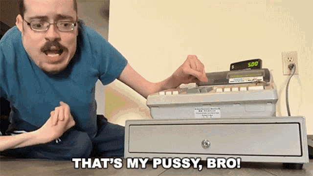 a man sitting on the floor with the words that 's my pussy bro on the bottom