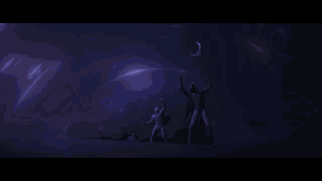 a group of people standing in the dark with a rainbow in the sky