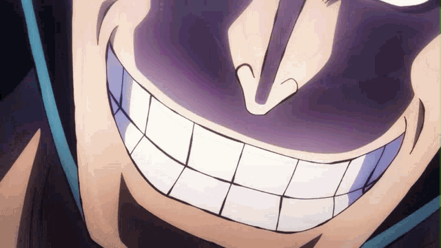 a close up of a man 's face with a huge smile