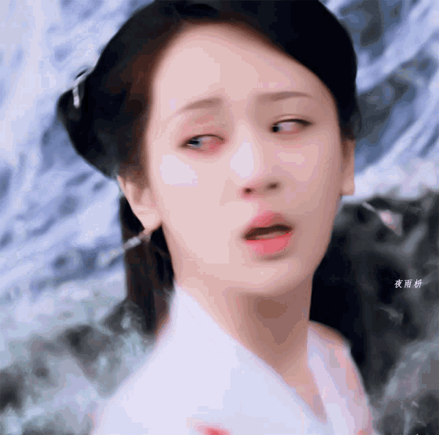 a close up of a woman 's face with chinese writing on the bottom right corner