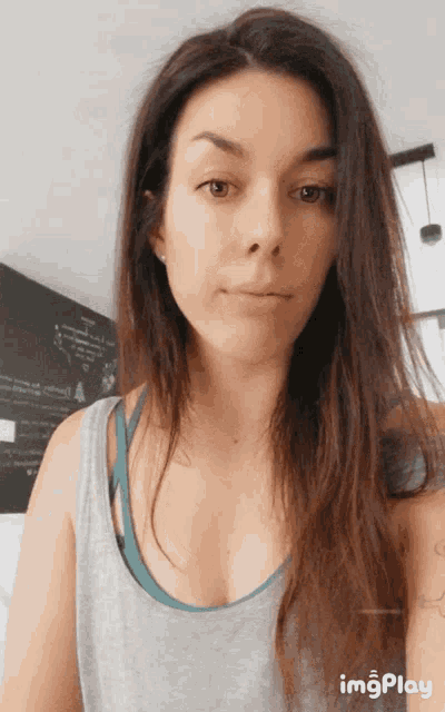a woman 's face is shown in a gif that says imgplay on the bottom