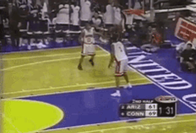 a basketball game is being played on a court with united written on the side .