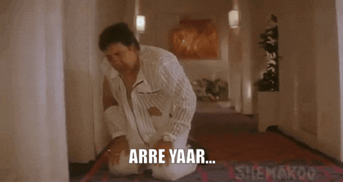 a man is kneeling down in a hallway with the words udhar kyun maar rahe ho ??