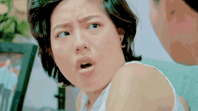a close up of a woman making a face with her mouth open