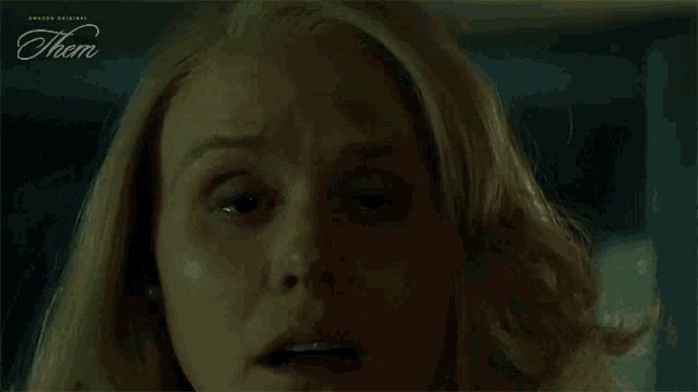 a close up of a woman 's face with the word them on the bottom left