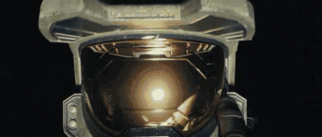a close up of an astronaut 's helmet with a light coming out of it