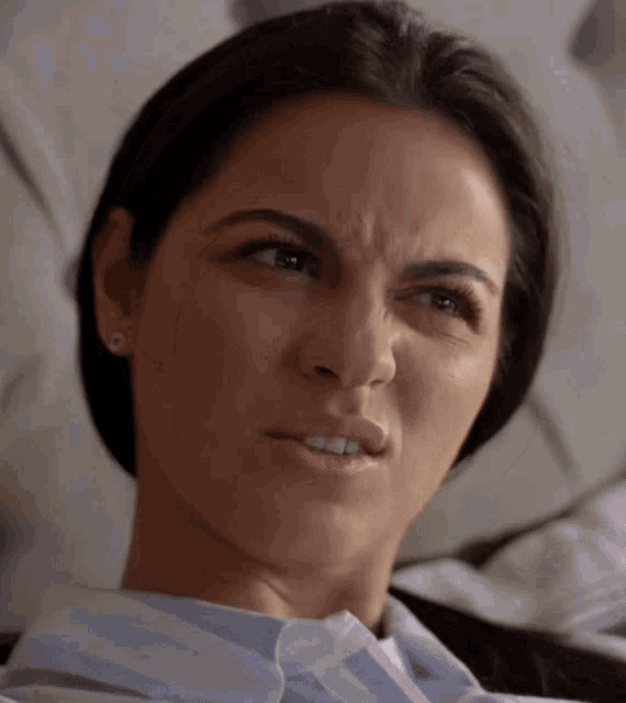 a close up of a woman making a face
