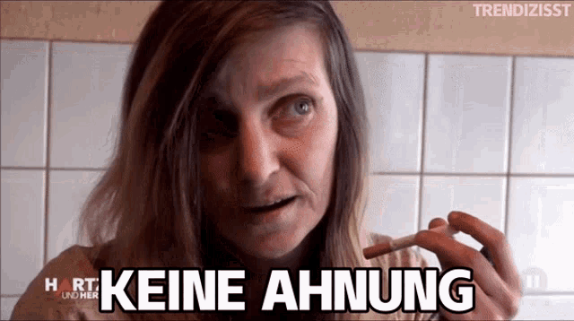 a woman smoking a cigarette with the words " keine ahnung " on her face