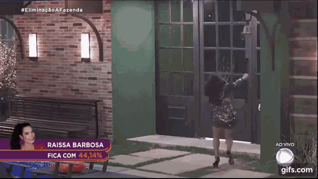 a woman in a short dress is dancing in front of a green wall