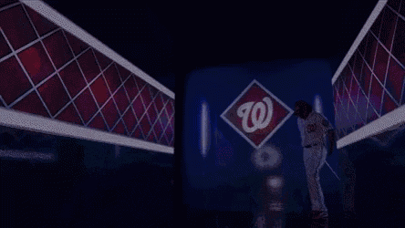 a baseball player is standing in a tunnel with a washington nationals logo in the background