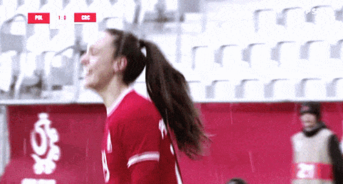 a female soccer player wearing a red jersey with the number 5 on it