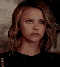 a close up of a woman 's face with a serious expression .