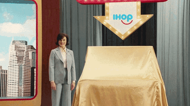 a woman is standing in front of a sign that says ihop