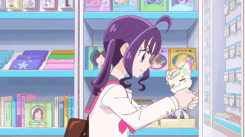 a girl with purple hair is holding a stuffed animal in her hands