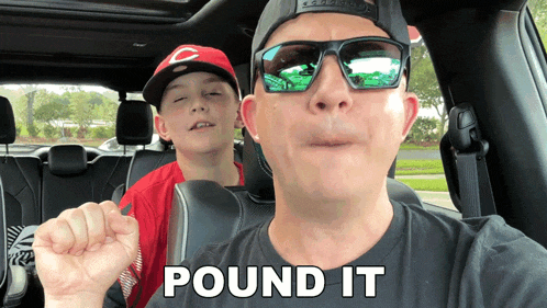a man and a boy in a car with the words " pound it " on the front