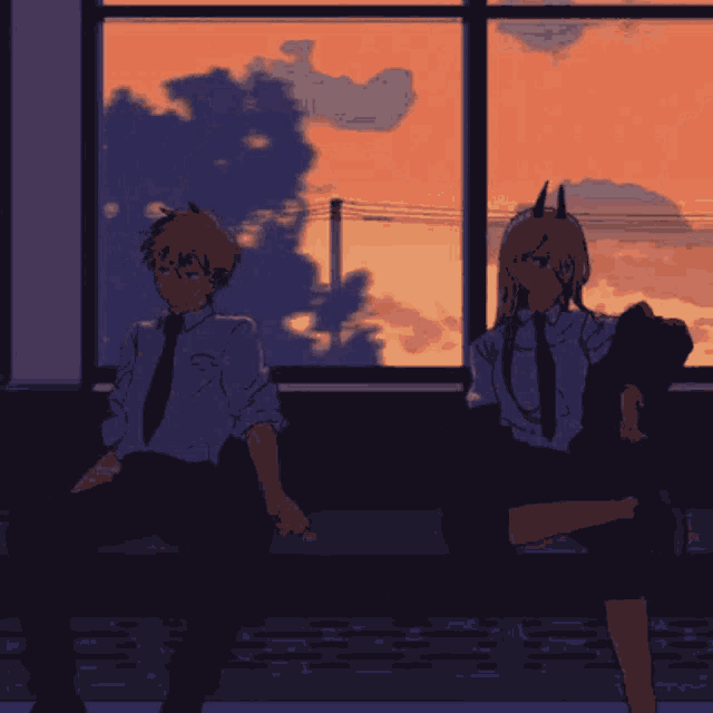 a boy and a girl sit next to each other in front of a window