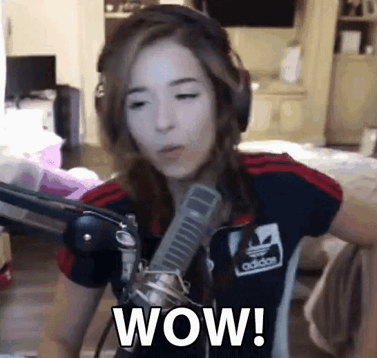 a woman wearing headphones and an adidas shirt is sitting in front of a microphone and says wow .