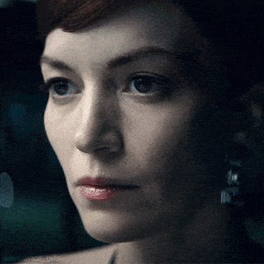 a close up of a woman 's face with the words severance gifs below her
