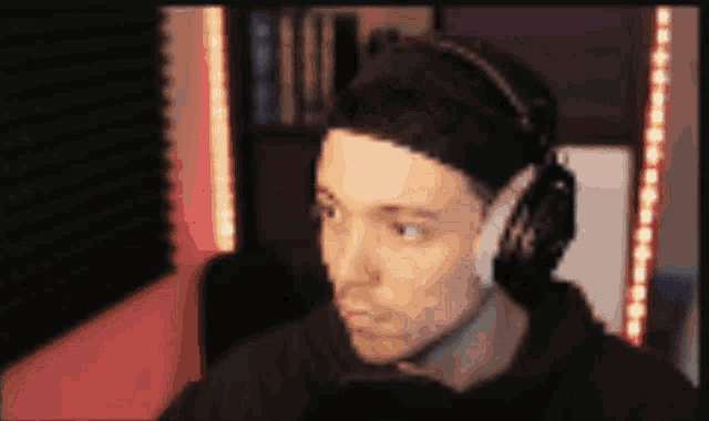 a man wearing headphones is looking at something