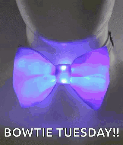 a person wearing a glow in the dark bow tie with the words bowtie tuesday written below it .