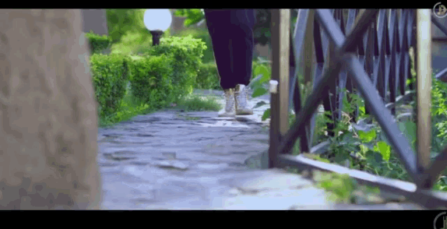 a person walking down a path with the letter d on the bottom