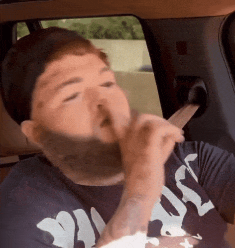 a man with a beard wearing a shirt that says " jesus "