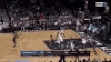 a blurry picture of a basketball game being played on a court .