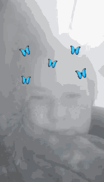 a child with blue butterflies on their face