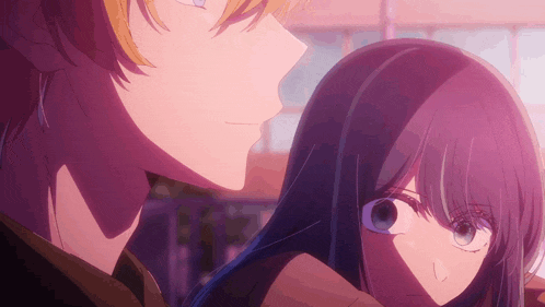 a boy and a girl are looking at each other in a close up