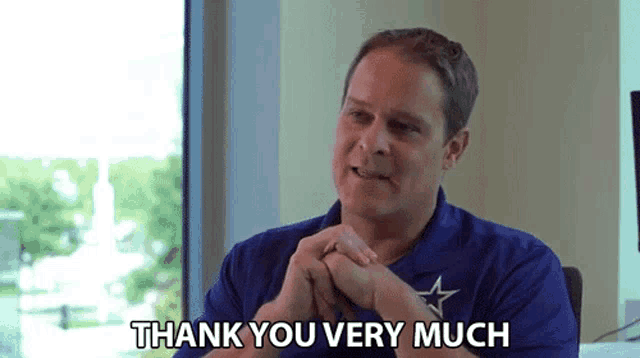 a man in a blue shirt with a star on it says " thank you very much "