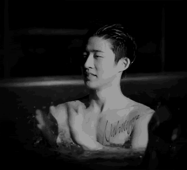 a shirtless man with a tattoo on his chest that says waiting