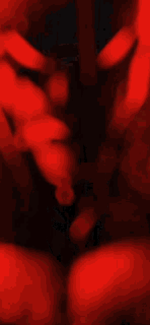 a blurry picture of a person 's face in a red light .