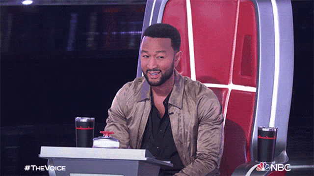 a man sitting in a chair with a nbc logo on the bottom right